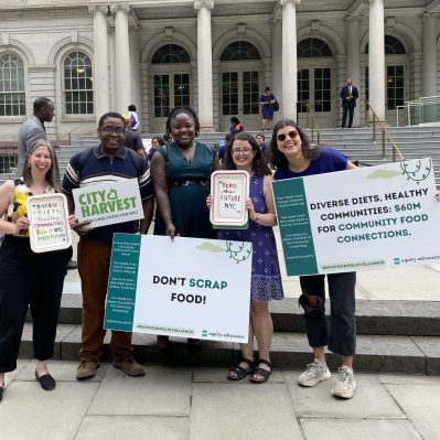 City Harvest Advocacy team at City Hall with signs.